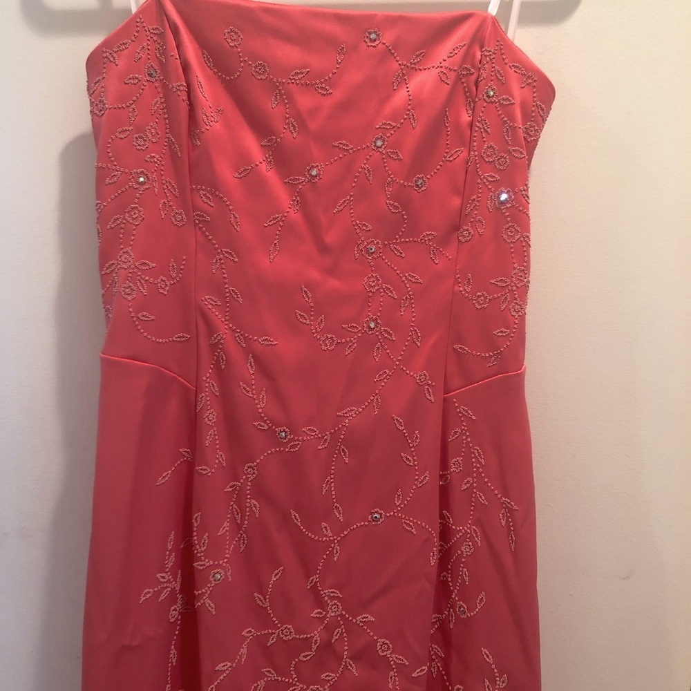 This dress is coral colored & has a small train.